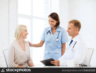 healthcare and medical concept - doctor and nurse with patient in hospital