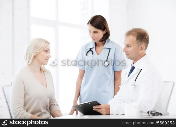 healthcare and medical concept - doctor and nurse with patient in hospital