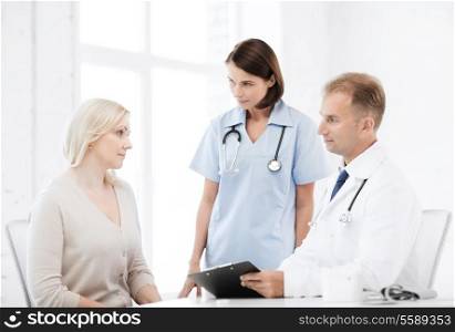 healthcare and medical concept - doctor and nurse with patient in hospital