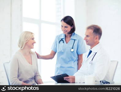 healthcare and medical concept - doctor and nurse with patient in hospital. doctor with patient in hospital