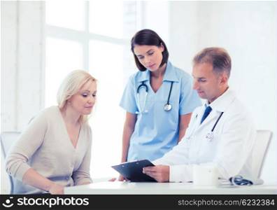 healthcare and medical concept - doctor and nurse with patient in hospital. doctor with patient in hospital