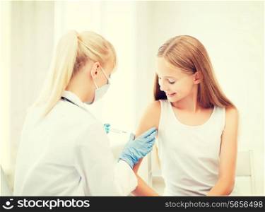 healthcare and medical concept - doctor doing vaccine to child in hospital