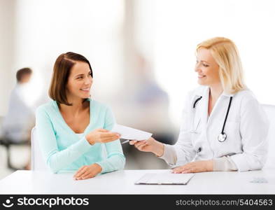 healthcare and medical concept - doctor giving prescription to patient in hospital