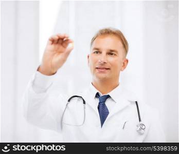healthcare and medical concept - doctor holding omega 3 capsule