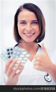 healthcare and medical concept - doctor with blister packs of pills. doctor with blister packs of pills