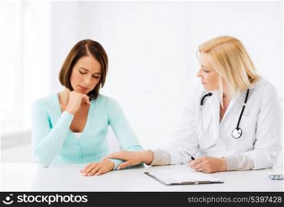 healthcare and medical concept - doctor with patient in hospital