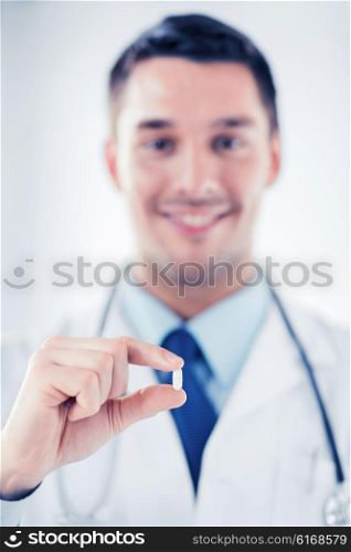 healthcare and medical concept - doctor with pill in hospital. doctor with pill in hospital
