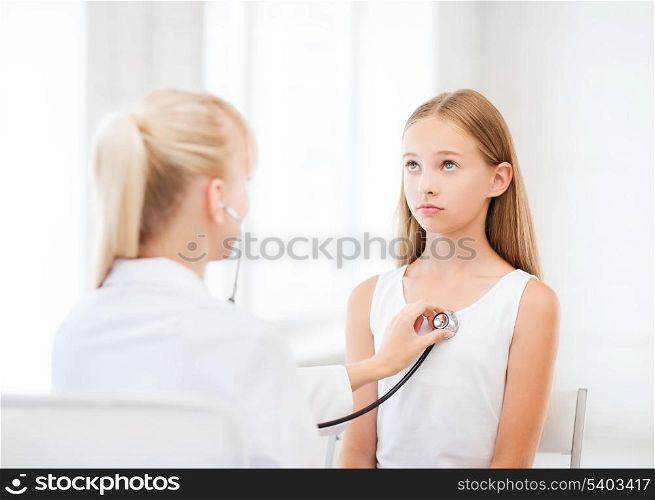 healthcare and medical concept - doctor with stethoscope listening to child chest in hospital
