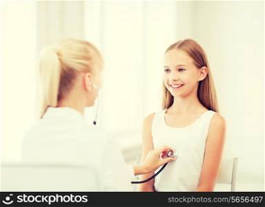 healthcare and medical concept - doctor with stethoscope listening to child chest in hospital