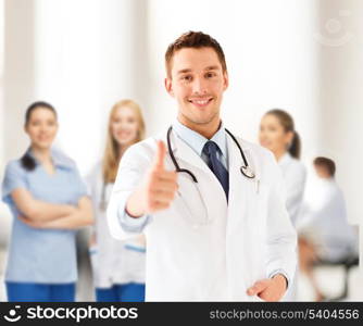 healthcare and medical concept - doctor with stethoscope showing thumbs up