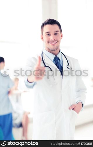 healthcare and medical concept - doctor with stethoscope showing thumbs up. doctor with stethoscope showing thumbs up