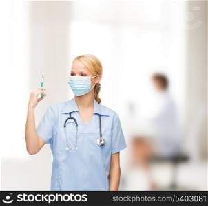 healthcare and medical concept - female doctor or nurse in medical mask holding syringe with injection