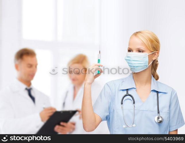 healthcare and medical concept - female doctor or nurse in medical mask holding syringe with injection