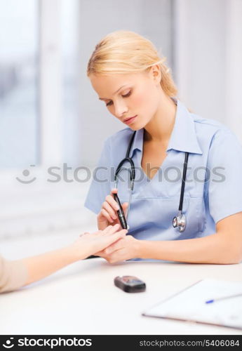 healthcare and medical concept - female doctor or nurse with patient measuring blood sugar value