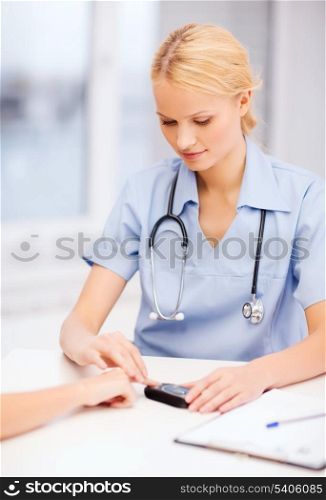 healthcare and medical concept - female doctor or nurse with patient measuring blood sugar value