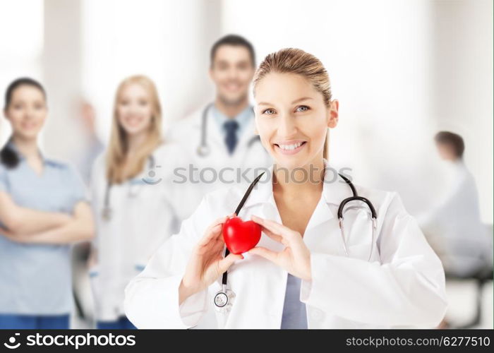 healthcare and medical concept - female doctor with heart