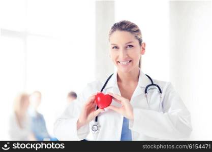 healthcare and medical concept - female doctor with heart. female doctor with heart
