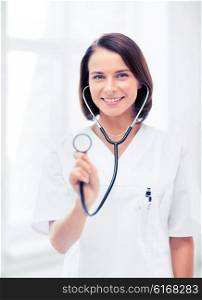 healthcare and medical concept - female doctor with stethoscope. female doctor with stethoscope