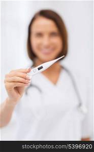 healthcare and medical concept - female doctor with thermometer and stethoscope