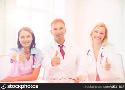 healthcare and medical concept - group of doctors on a meeting showing thumbs up. doctors on a meeting
