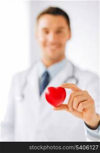 healthcare and medical concept - male doctor with heart