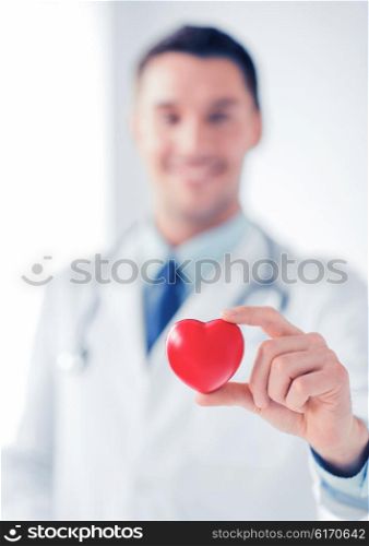 healthcare and medical concept - male doctor with heart. male doctor with heart