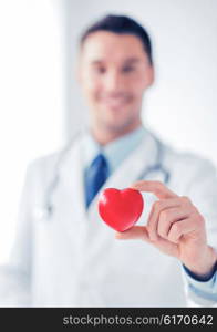 healthcare and medical concept - male doctor with heart. male doctor with heart