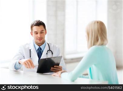 healthcare and medical concept - male doctor with patient in hospital