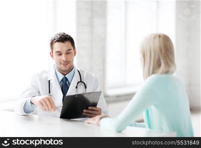 healthcare and medical concept - male doctor with patient in hospital