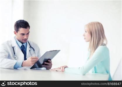healthcare and medical concept - male doctor with patient in hospital. doctor with patient in hospital
