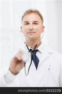healthcare and medical concept - male doctor with stethoscope
