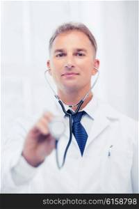 healthcare and medical concept - male doctor with stethoscope. male doctor with stethoscope