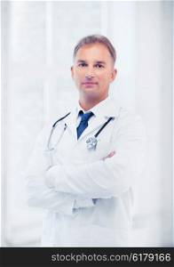 healthcare and medical concept - male doctor with stethoscope. male doctor with stethoscope