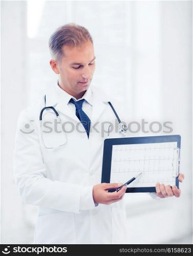 healthcare and medical concept - male doctor with stethoscope showing cardiogram. male doctor with stethoscope showing cardiogram