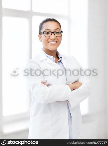 healthcare and medical concept - smiling african female doctor in hospital