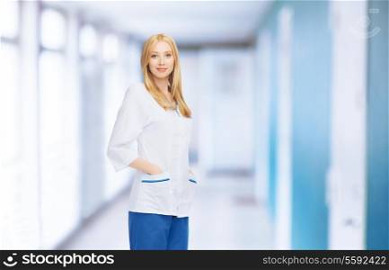 healthcare and medical concept - smiling female doctor or nurse in medical facility