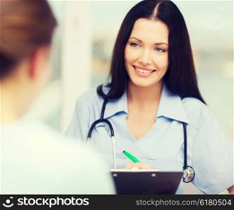 healthcare and medical concept - smiling female doctor or nurse with patient writing prescription. smiling doctor or nurse with patient