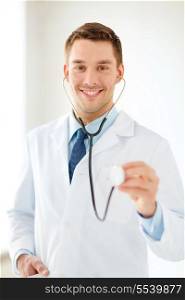 healthcare and medical concept - smiling male doctor with stethoscope in hospital