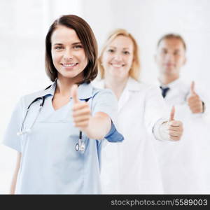 healthcare and medical concept - team of doctors showing thumbs up