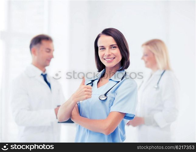 healthcare and medical concept - team of doctors showing thumbs up. team of doctors showing thumbs up