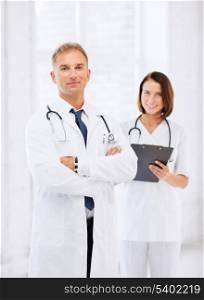 healthcare and medical concept - two doctors in hospital