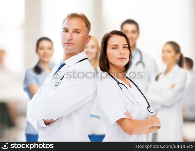 healthcare and medical concept - two doctors with stethoscopes