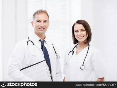 healthcare and medical concept - two doctors with stethoscopes