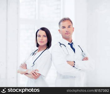 healthcare and medical concept - two doctors with stethoscopes. two doctors with stethoscopes