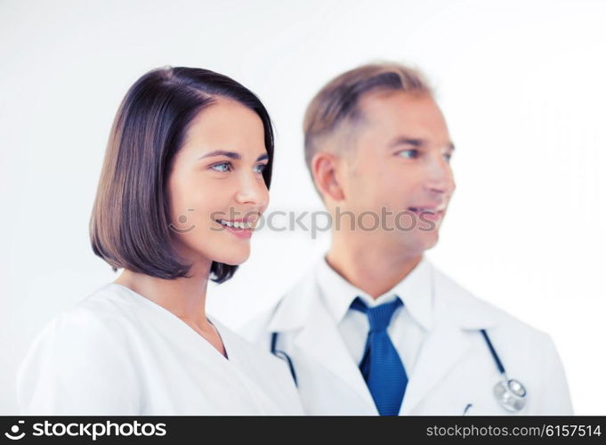 healthcare and medical concept - two doctors with stethoscopes. two doctors with stethoscopes