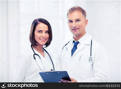 healthcare and medical concept - two doctors with stethoscopes. two doctors with stethoscopes