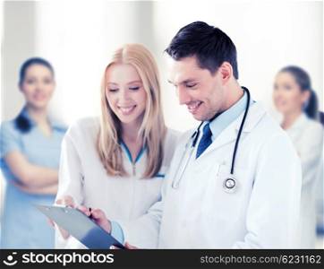 healthcare and medical concept - two doctors writing prescription. two doctors writing prescription