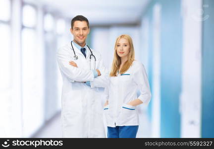 healthcare and medical concept - two young attractive doctors in medical facility