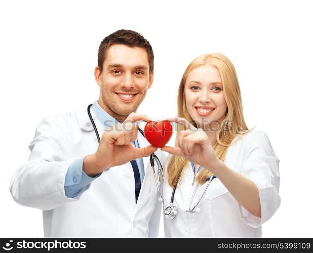 healthcare and medical concept - two young doctors cardiologists with heart