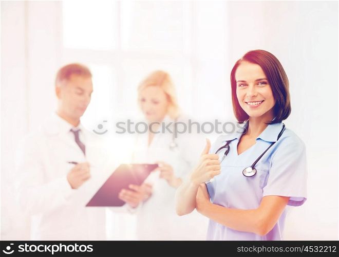 healthcare and medical concept - young female doctor with stethoscope. young female doctor with stethoscope